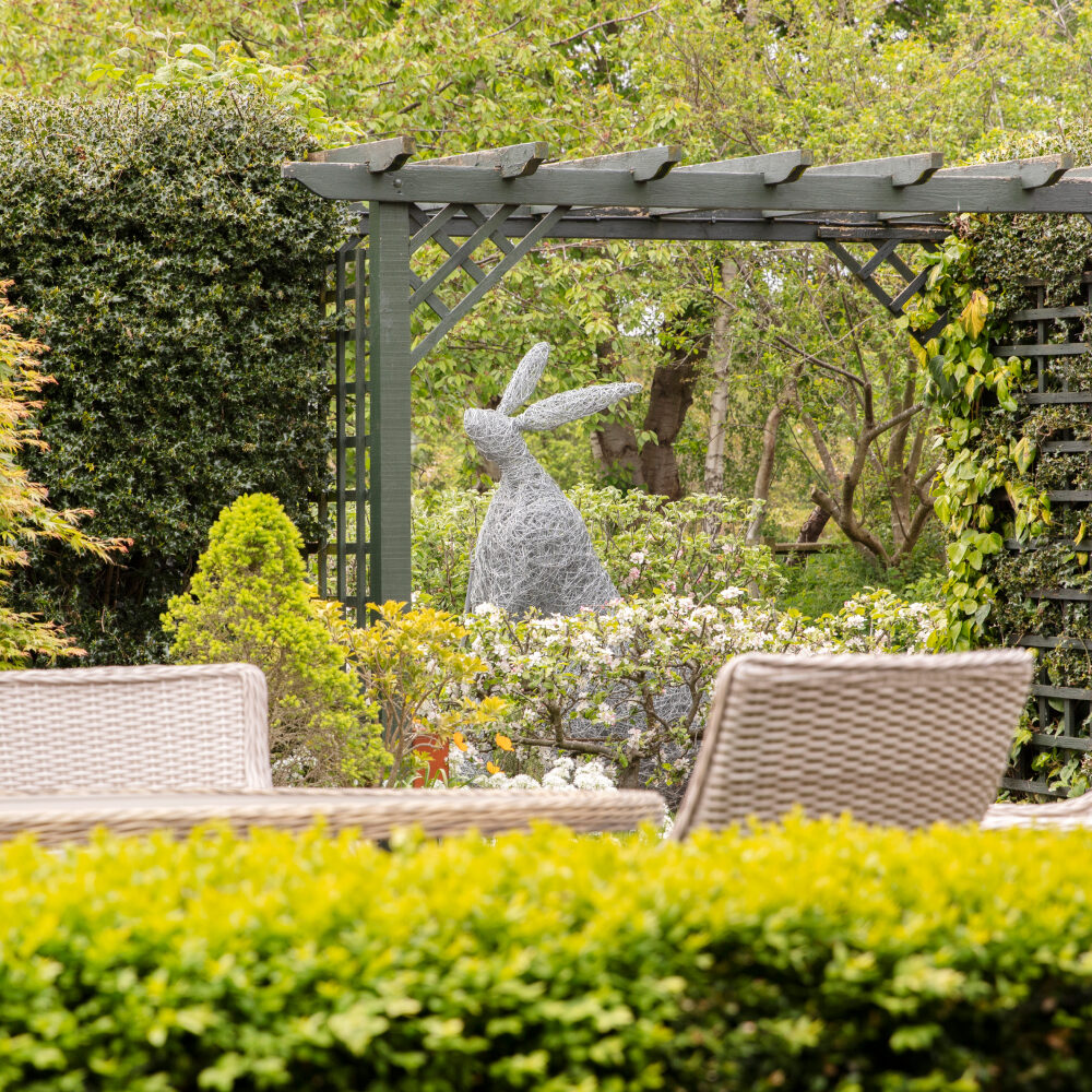 Garden with rabbit sculpture